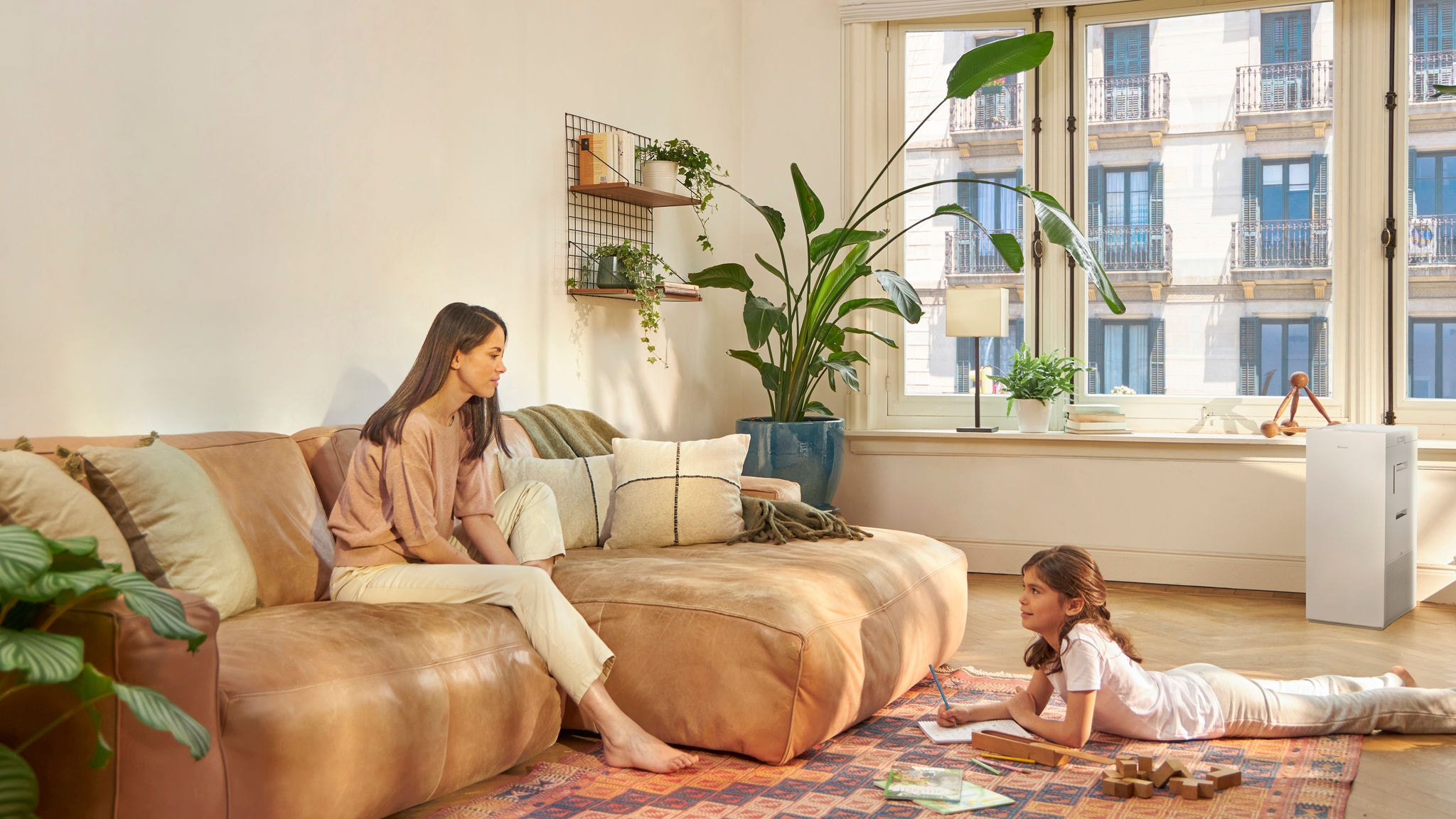 Mother and child reading a book on the floor in clean air