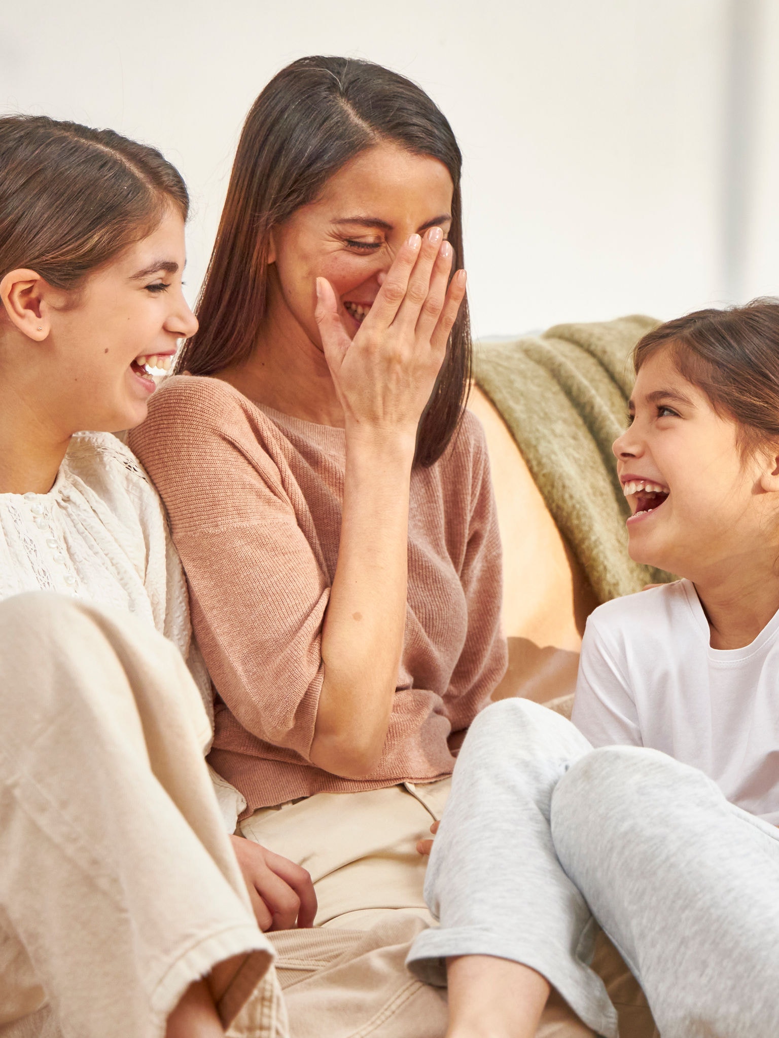 Mother and daughters having a fun day in a perfectly heated room 